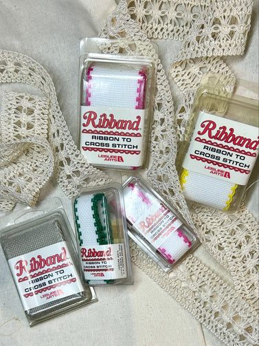 Packaged ribbon for cross stitch on a lace background