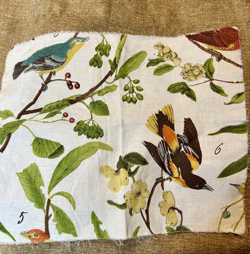 Fabric panel with birds and foliage on a beige background